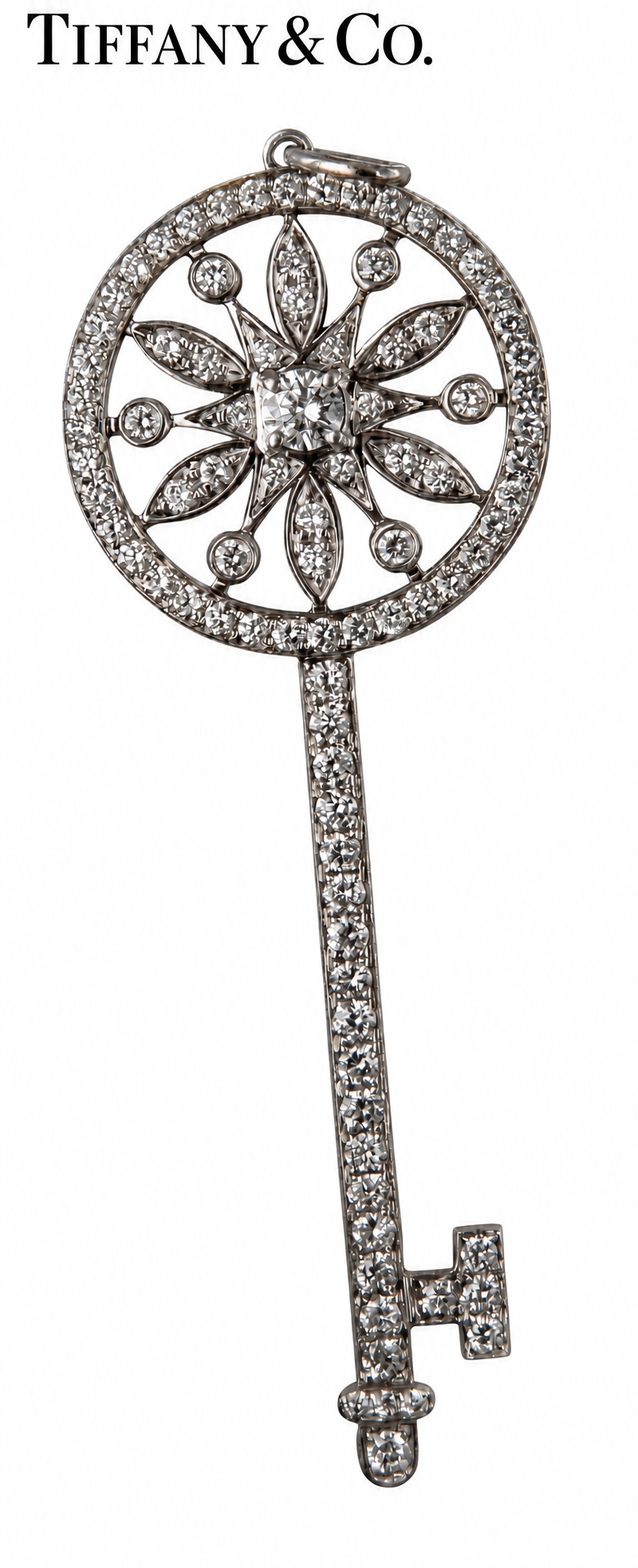 A TIFFANY AND CO. 18K WHITE GOLD, DIAMOND ENCRUSTED KEY PENDANT. Pave ...