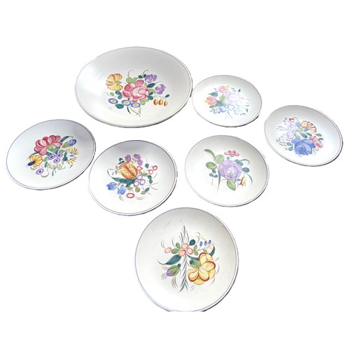 1 - A Poole Pottery set of six plates and one large serving bowl with floral motifs from the 