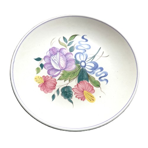 1 - A Poole Pottery set of six plates and one large serving bowl with floral motifs from the 