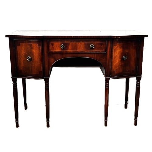 4 - A reproduction mahogany serpentine fronted sideboard, with shaped top above a series of drawers and ... 