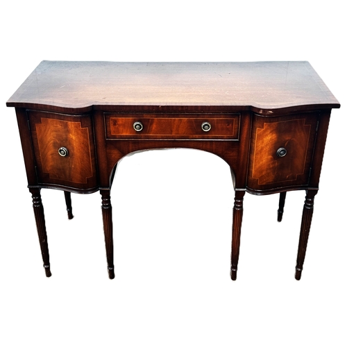 4 - A reproduction mahogany serpentine fronted sideboard, with shaped top above a series of drawers and ... 