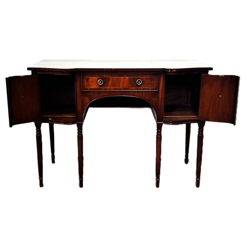 4 - A reproduction mahogany serpentine fronted sideboard, with shaped top above a series of drawers and ... 