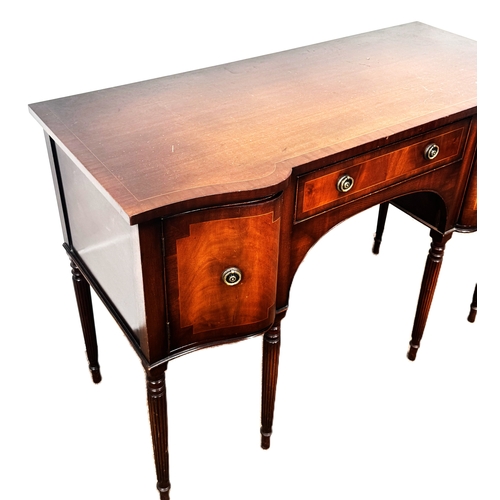 4 - A reproduction mahogany serpentine fronted sideboard, with shaped top above a series of drawers and ... 