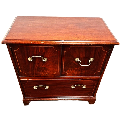 17 - A mahogany inlaid cabinet, with two cabinet doors over a single long drawer,W79cm x H70cm x D37cm... 