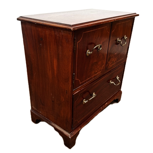 17 - A mahogany inlaid cabinet, with two cabinet doors over a single long drawer,W79cm x H70cm x D37cm... 