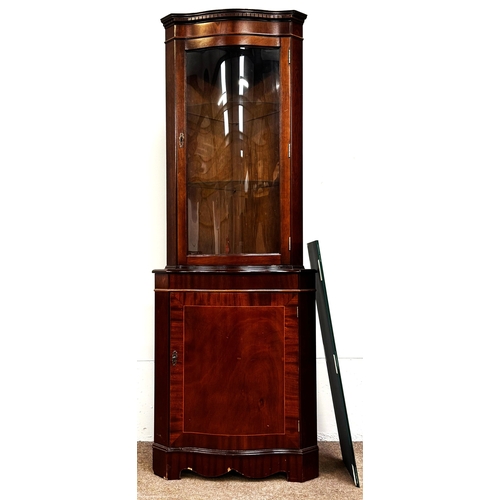 21 - A mahogany veneered George III reproduction corner cabinet; 179cm high, 65cm width, 44cm depth.