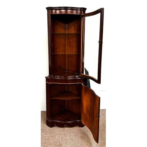 21 - A mahogany veneered George III reproduction corner cabinet; 179cm high, 65cm width, 44cm depth.
