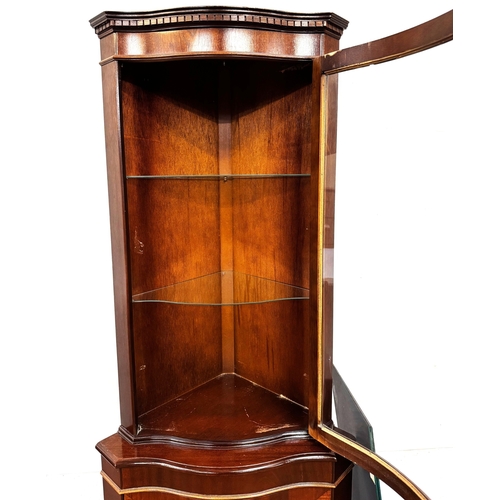 21 - A mahogany veneered George III reproduction corner cabinet; 179cm high, 65cm width, 44cm depth.