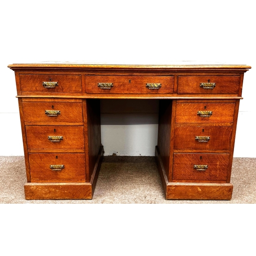 22 - A late Victorian oak pedestal desk, circa 1900,with leathered top, and arrangement of nine drawers; ... 