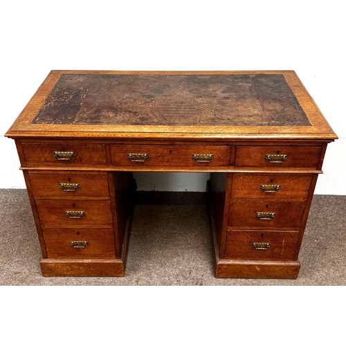 22 - A late Victorian oak pedestal desk, circa 1900,with leathered top, and arrangement of nine drawers; ... 
