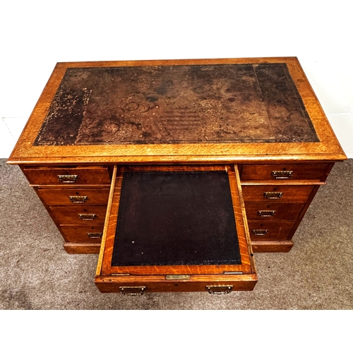 22 - A late Victorian oak pedestal desk, circa 1900,with leathered top, and arrangement of nine drawers; ... 