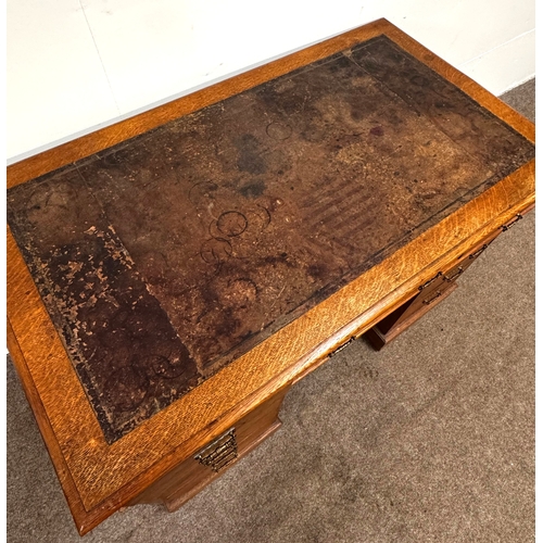 22 - A late Victorian oak pedestal desk, circa 1900,with leathered top, and arrangement of nine drawers; ... 