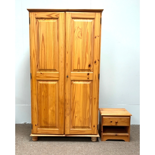 32 - A modern pine two door wardrobe; with a small bedside chest (2).Wardrobe; 186cm high, 102cm width, 5... 