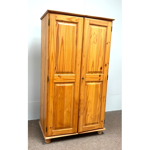 32 - A modern pine two door wardrobe; with a small bedside chest (2).Wardrobe; 186cm high, 102cm width, 5... 