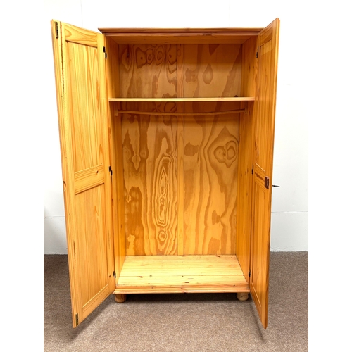 32 - A modern pine two door wardrobe; with a small bedside chest (2).Wardrobe; 186cm high, 102cm width, 5... 