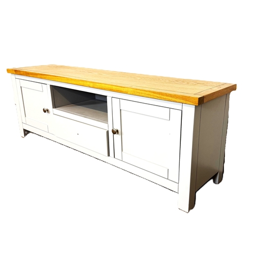 39 - A modern painted light grey television stand; 48cm high, 140cm width, 35cm depth.