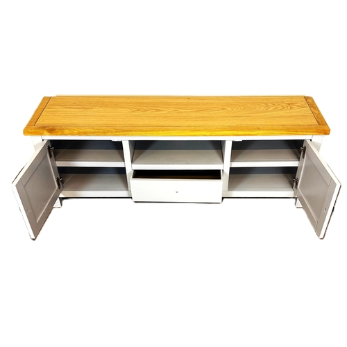 39 - A modern painted light grey television stand; 48cm high, 140cm width, 35cm depth.