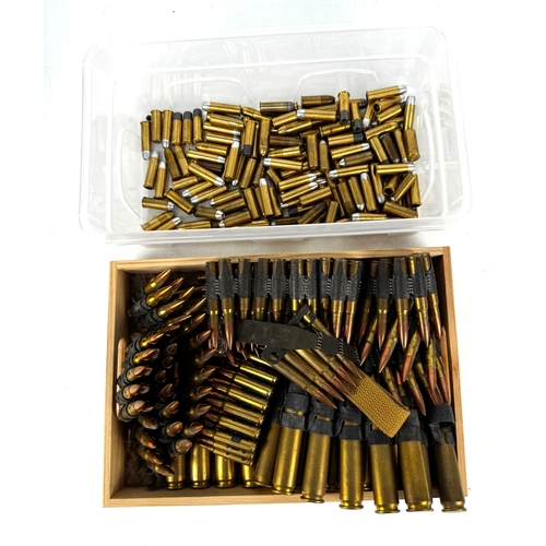 A selection of inert ammunition, including linked rifle rounds, loose ...