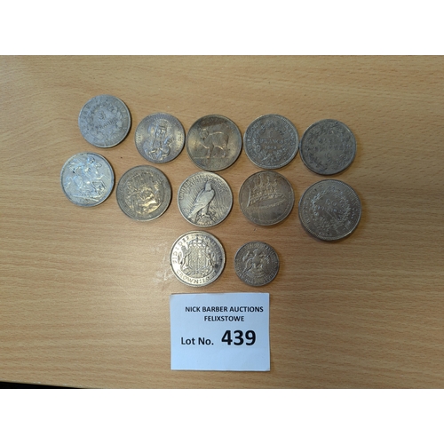 439 - Coins: Assortment of GB/Foreign silver crowns; tarnishing throughout; (12).