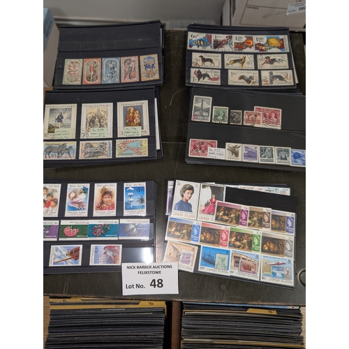 48 - Stamps: Metal drawers containing approx. 700 cards of world stamps; all periods; ordered alphabetica... 