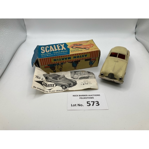 573 - Diecast: Scalex tinplate Aston Martin DB2; cream/beige exterior with orange interior, black base and... 