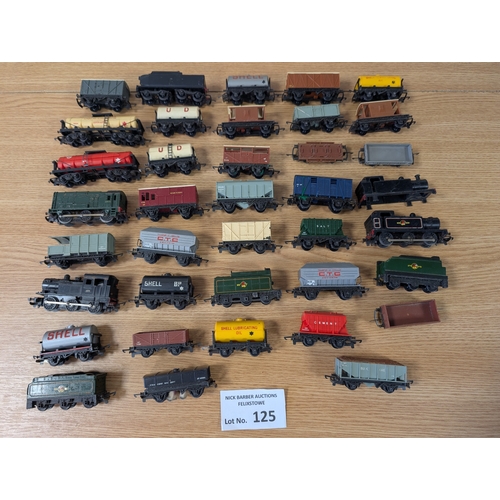 125 - Trains: 2 boxes of assorted engines, carriages, trucks, buildings, and other accessories; conditions... 