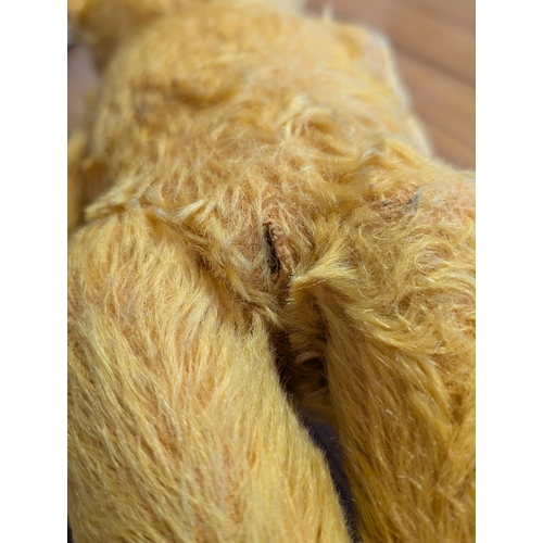 215 - Teddy Bears: Chiltern Hugmee 1940s-50s golden mohair teddy bear, with glass amber and black eyes, ve... 