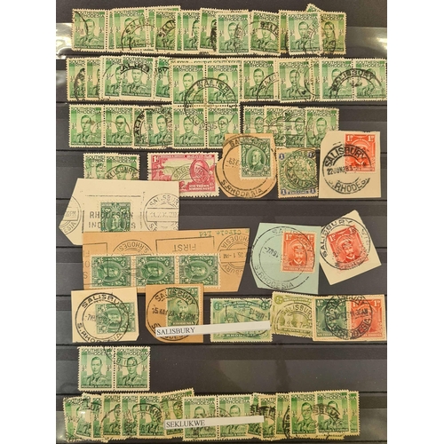 49 - ** BRITISH AFRICA CANCELLATIONS: Three stock books housing an accumulation of adhesives with much po... 