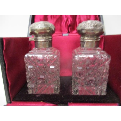 1 - A pair of clear glass and silver scent bottles by Levie & Saloman, Birmingham 1901, with hinged, emb... 