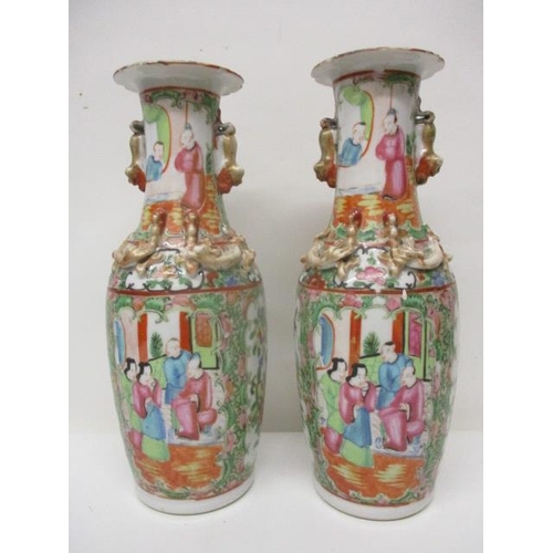 196 - A pair of 19th century Chinese Canton famille vert vases with applied dragons and twin gilt dog hand... 