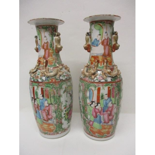 196 - A pair of 19th century Chinese Canton famille vert vases with applied dragons and twin gilt dog hand... 