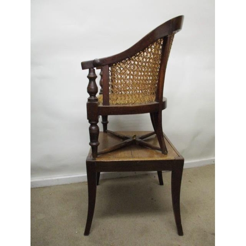 199 - A Victorian mahogany child's Berger style, curved back chair with a caned back and seat, raised on r... 