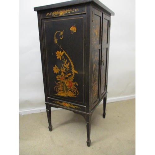 202 - An early 20th century chinoiserie decorated and black painted music cabinet with twin panelled doors... 