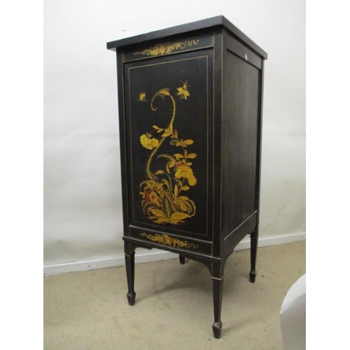 202 - An early 20th century chinoiserie decorated and black painted music cabinet with twin panelled doors... 