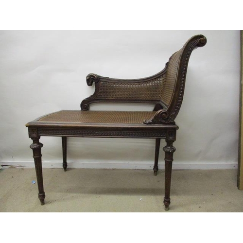 205 - A late 19th century Louis XVI style beech window seat, having a carved rams mask handle, caned back,... 