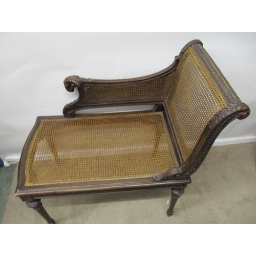 205 - A late 19th century Louis XVI style beech window seat, having a carved rams mask handle, caned back,... 