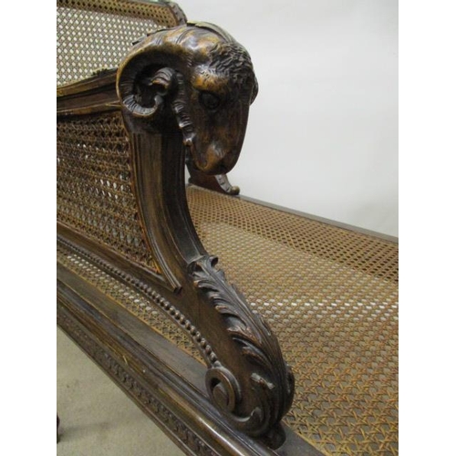 205 - A late 19th century Louis XVI style beech window seat, having a carved rams mask handle, caned back,... 