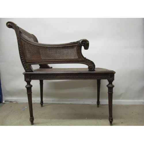 205 - A late 19th century Louis XVI style beech window seat, having a carved rams mask handle, caned back,... 