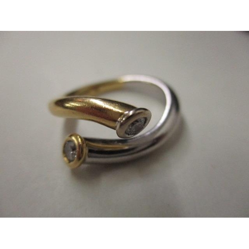 71 - An 18ct white and yellow gold designer ring, each end set with a diamond, 5.2g