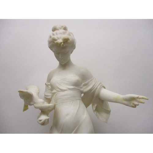 238 - A late 19th century carved white alabaster figure of a woman holding a small pedestal bowl, with a b... 