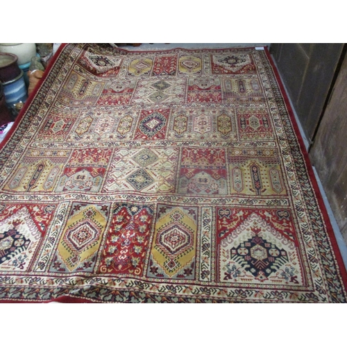 347 - A Persian design, machine made carpet with panels on a red ground, 130