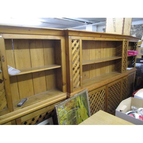 351 - A large modern pine bookcase having fitted shelves and cupboard doors below, 70 1/4