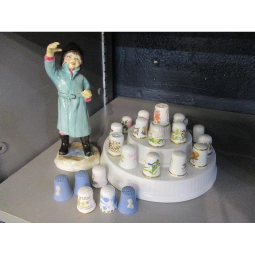 85 - A collection of thimbles, together with a Royal Worcester figure entitled February