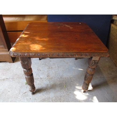 425 - A late Victorian carved oak extending dining table, raised on turned legs