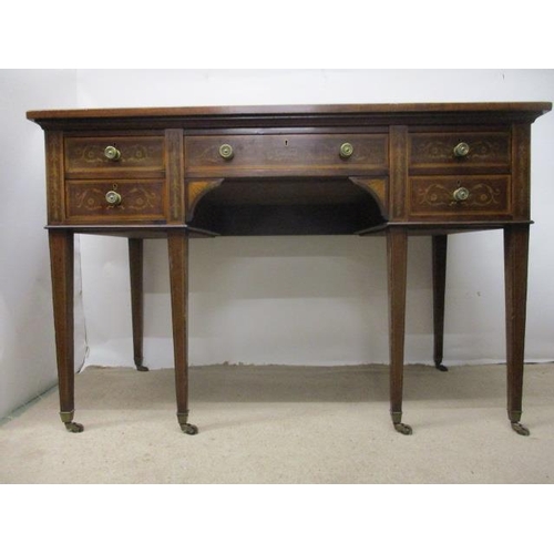 126 - A Victorian mahogany and marquetry desk having a drawer flanked by four drawers, with scrolled folia... 