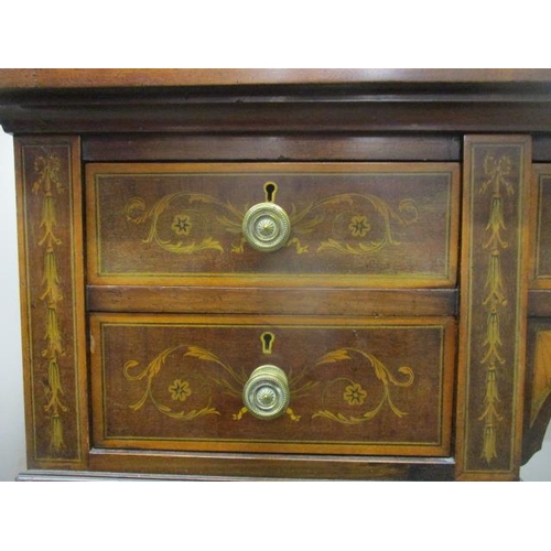 126 - A Victorian mahogany and marquetry desk having a drawer flanked by four drawers, with scrolled folia... 