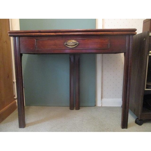 191 - WITHDRAWN  A George III mahogany tea table having a foldover top, over a frieze drawer, raised on sq... 