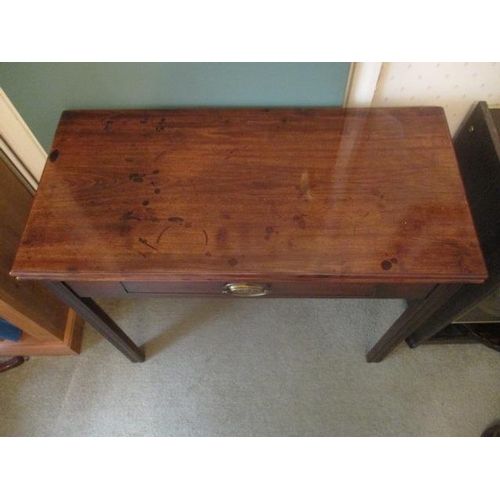 191 - WITHDRAWN  A George III mahogany tea table having a foldover top, over a frieze drawer, raised on sq... 