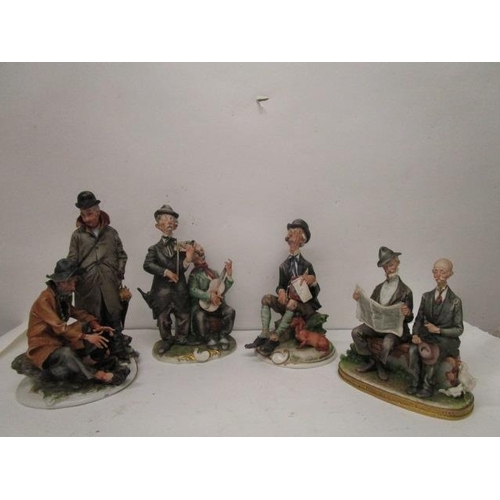 199 - A group of four Capodimonte porcelain figurines, three Galli figures to include a couple sitting on ... 