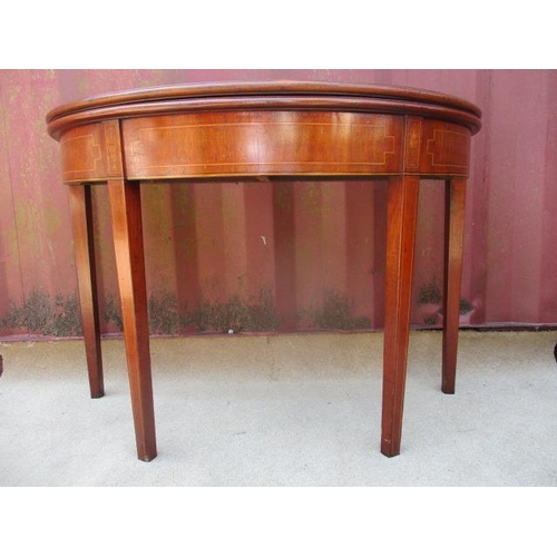 204 - A 19th century mahogany and marquetry demi lune tea table with foldover top, raised on square, taper... 